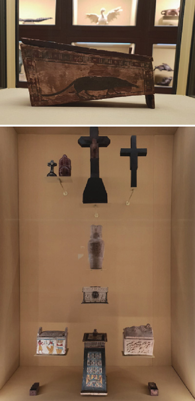 (Top) Ancient Egyptian coffin containing a giant mummified shrew at the center of the exhibition hall. Image courtesy of Lee Nara. (Bottom) Exhibition view of Spitzmaus Mummy in a Coffin and other Treasures, Kunsthistorisches Museum Wien, 2018–2019. Image courtesy of Lee Nara.