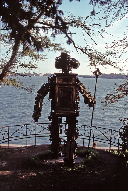 Installation view of NAM JUNE PAIK’s Tangun as Scythian King, 1993, welded steel framework with old television chassis and picture tubes, neon, large brass mail box, and metal pole staff with speakers, dimensions variable.